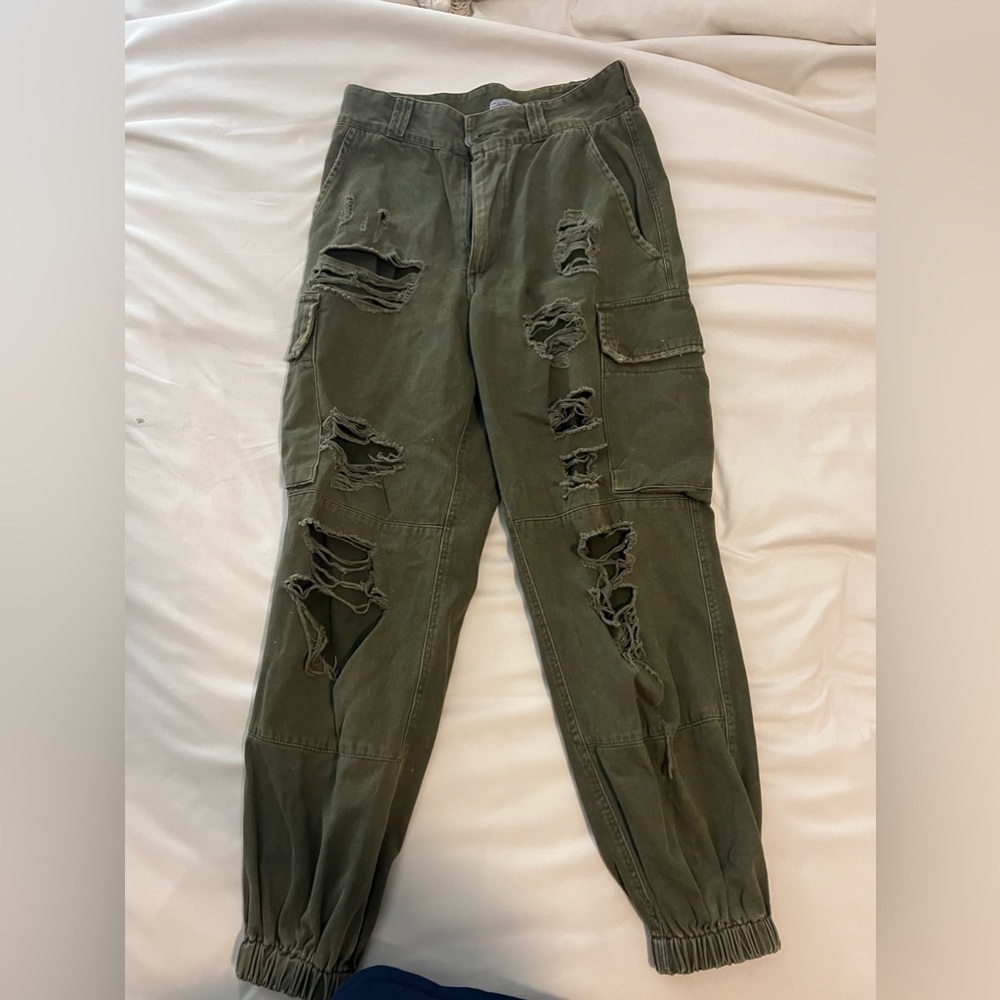 olive green ripped cargo pants. tight band around the ankles. size 6